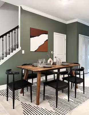 a dining room with a wooden table and black chairs at Last Minute Disney Luxury Townhouse with Private Pool. Book Now SLR557 in Kissimmee
