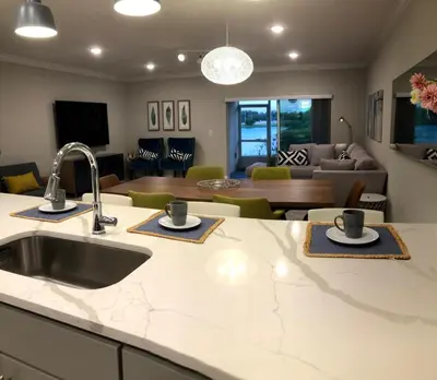 a kitchen with a sink and a living room at NEW Home 3 Bedrooms Water View Disney Universal in Kissimmee