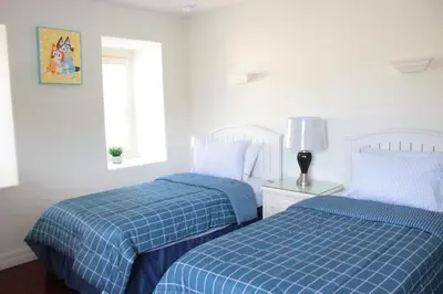 two beds sitting next to each other in a bedroom at Relaxing Villa near the Parks! in Orlando