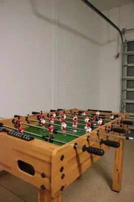 a wooden foosball table with players on it at Relaxing Villa near the Parks! in Orlando