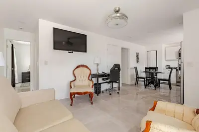 a living room with a couch and a table at Paradise Apartment in Orlando