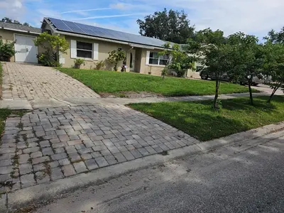 a brick driveway in front of a house at Paradise Apartment in Orlando