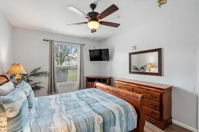 a bedroom with a bed and a ceiling fan at 2302 Butterfly Palm 102 in Kissimmee