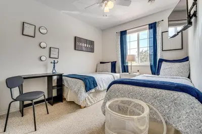 a bedroom with two beds and a desk and a window at 10 Mi to Disney World Townhome with Community Pool! in Kissimmee