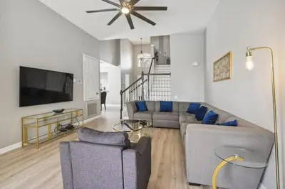 a living room with two couches and a television at Paradise Villa in Orlando