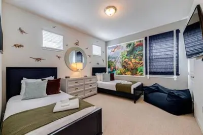 a bedroom with two beds and a mirror at RVH7391 - Five Bed Luxury Disney Vacation Retreat in Orlando