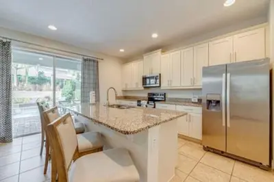 a large kitchen with a stainless steel refrigerator at RVH7391 - Five Bed Luxury Disney Vacation Retreat in Orlando