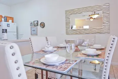 a dining room with a glass table and chairs at Plunge Pool Oasis Bella Vida Resort Close to Parks in Kissimmee