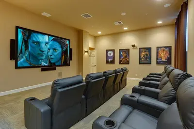 a movie room with leather chairs and a flat screen tv at Plunge Pool Oasis Bella Vida Resort Close to Parks in Kissimmee