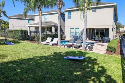 a yard with a ping pong table in front of a house at Magical Getaway Near Disney I Pool and Fun Room in Orlando