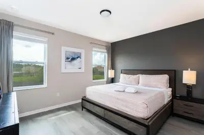 a bedroom with a large bed and a window at Casa Familiar c/ Piscina 9 Quartos Perto Disney in Kissimmee