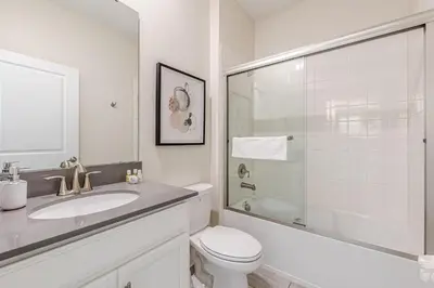 a bathroom with a toilet and a sink and a shower at 2807 - Storybook Escape in Kissimmee