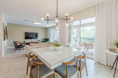 a dining room and living room with a table and chairs at 2807 - Storybook Escape in Kissimmee