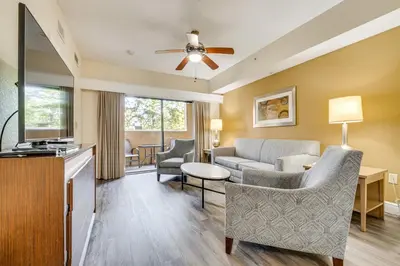 a living room with a couch and a table at Floridays Resort Condo 11 Mi to Walt Disney World! in Orlando
