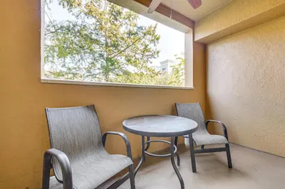 a table and chairs in a room with a window at Floridays Resort Condo 11 Mi to Walt Disney World! in Orlando