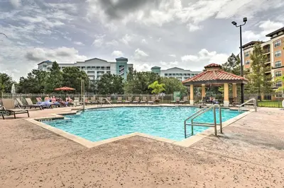 a swimming pool with a gazebo in a city at Floridays Resort Condo 11 Mi to Walt Disney World! in Orlando