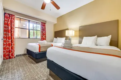 a hotel room with two beds and a window at Floridays Resort Condo 11 Mi to Walt Disney World! in Orlando