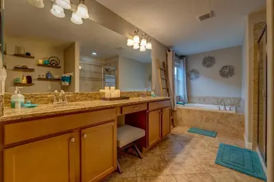 a large bathroom with two sinks and a tub at NEW, Disney,10mi, Themed Rooms, PvtPool, Movie, Game Room in Kissimmee
