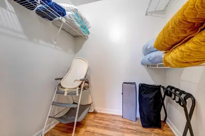 a room with a walk in closet with a chair at Mickey's Cozy Condo Retreat in Kissimmee