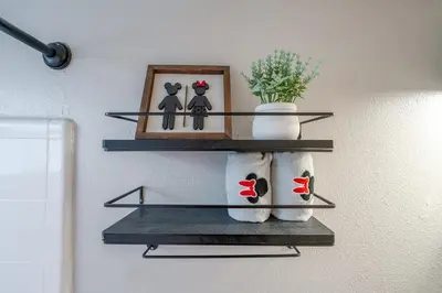 a shelf with two cats and a picture on a wall at Mickey's Cozy Condo Retreat in Kissimmee