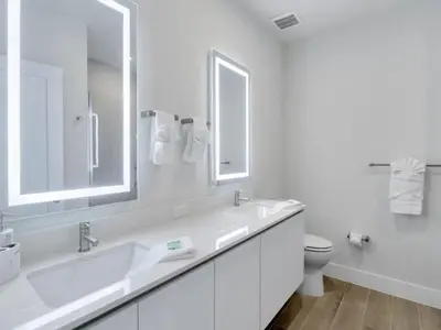 a white bathroom with two sinks and a toilet at TR17226BD - 4 bedr w/pool - 10 guests Near Disney in Orlando