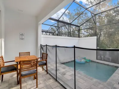 a house with a swimming pool and a table and chairs at TR17226BD - 4 bedr w/pool - 10 guests Near Disney in Orlando