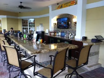 a bar in a restaurant with chairs around it at Seaescape in Orlando