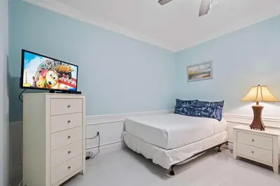 a bedroom with a bed and a tv on a dresser at Seaescape in Orlando