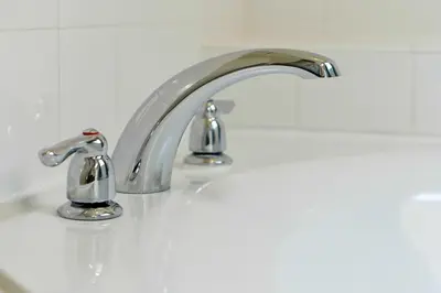 a bathroom sink with two faucets on it at 2616 TRANQUILITY KISSIMMEE 6 BED in Kissimmee