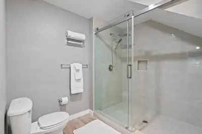a bathroom with a shower and a toilet at 4 Bedroom 3 Bathroom Villas At Seven Dwarfs 18-108 in Kissimmee