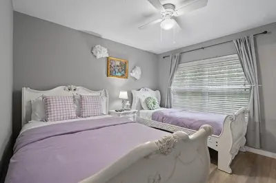 a bedroom with two beds and a ceiling fan at 4 Bedroom 3 Bathroom Villas At Seven Dwarfs 18-108 in Kissimmee