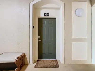 a green door in a hallway with a mattress next to it at Windsor Hills Magical Condo Pool Slides By Disney in Orlando
