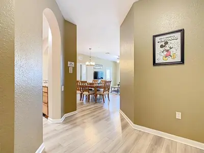 a dining room and living room with a dining table at Windsor Hills 3BR - Mickey Themed Spacious Condo in Orlando