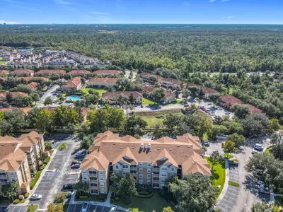 an aerial view of a apartment complex with a parking lot at Windsor Hills 3BR - Mickey Themed Spacious Condo in Orlando