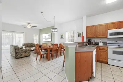 a kitchen and living room with a table and chairs at Resort stay Pool Access Peaceful Retreat Balcony in Kissimmee