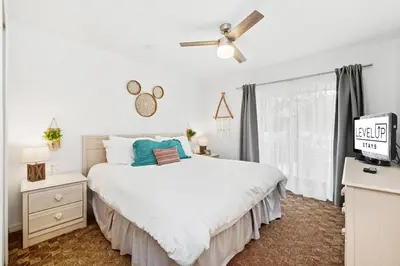 a white bedroom with a bed and a window at Resort stay Pool Access Peaceful Retreat Balcony in Kissimmee