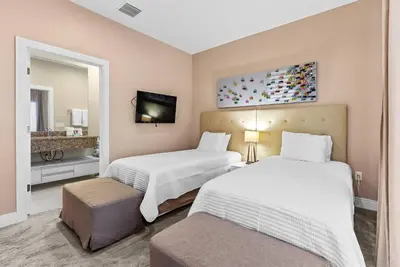 a hotel room with two beds and a tv at Home Luxury 03 Beds Close Disney At Magic Village in Orlando