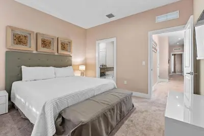 a bedroom with a large white bed and a bathroom at Home Luxury 03 Beds Close Disney At Magic Village in Orlando