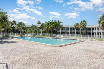 a swimming pool in front of a building at 2050 E IRLO BRONSON 1BED in Kissimmee