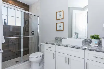 a bathroom with a toilet and a sink and a shower at Magic 5bd House 8 min from Disney in Orlando