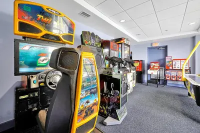 a room with arcade games and video game machines at Disney Dream Condo & Lake View Awaits in Orlando