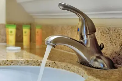 a sink with water running from a faucet at Disney Dream Condo & Lake View Awaits in Orlando