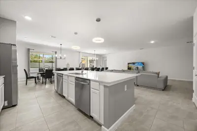 a large kitchen and living room with a table at 15 Bedrooms15 Bathrooms Veranda Palms 2393Sd in Kissimmee
