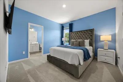 a blue bedroom with a bed and a blue wall at 15 Bedrooms15 Bathrooms Veranda Palms 2393Sd in Kissimmee