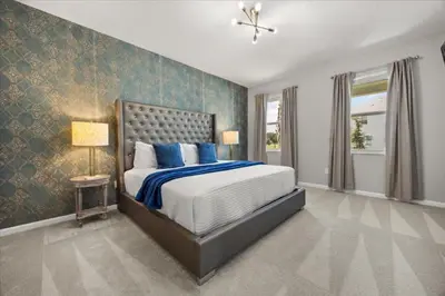 a bedroom with a large bed with blue and white sheets at 15 Bedrooms15 Bathrooms Veranda Palms 2393Sd in Kissimmee