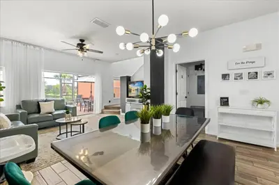 a living room with a glass table and chairs at 3 Bedrooms 3 Bathrooms Encantada Resort 3097Yl in Kissimmee