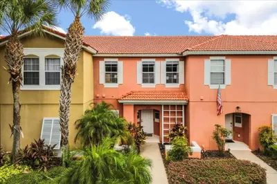 a house with palm trees in front of it at 3 Bedrooms 3 Bathrooms Encantada Resort 3097Yl in Kissimmee
