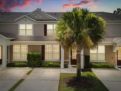 a palm tree in front of a house at 3 Bedrooms 3 Bathrooms Windsor Palms 2318Sp in Kissimmee