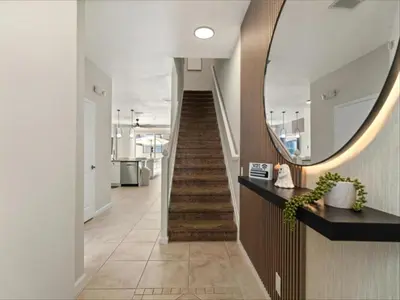 a hallway with a mirror and a staircase at 3 Bedrooms 3 Bathrooms Windsor Palms 2318Sp in Kissimmee
