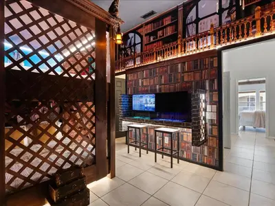 a living room with a wall of wine bottles at 3 Bedrooms 3 Bathrooms Windsor Palms 2318Sp in Kissimmee
